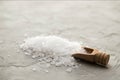 Sea salt crystals in wooden scoop close-up on concrete background. Small shovel with sea salt. Place for text Royalty Free Stock Photo