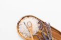 Sea salt heap and lavender on wooden tray