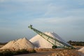 Sea salt piles and conveyor belt Royalty Free Stock Photo