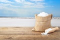 Sea salt in sack with salty lake in the background Royalty Free Stock Photo