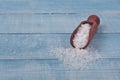 Sea salt in scoop on a wooden table Royalty Free Stock Photo