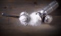 Sea salt with spoon and old aluminum salt shaker on wooden background, top view. Royalty Free Stock Photo