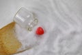 Grains of Natural Sea salt from a Upside down Glass bottle with red love