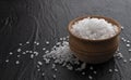 Sea salt in wooden bowl on black background Royalty Free Stock Photo