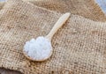 Sea salt in wooden spoon on burlap sack Royalty Free Stock Photo