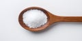 Sea Salt In Wooden Spoon On Light Background. Food Ingredient. Top View Of Pile White Mineral Crystal For Cooking. AI generated