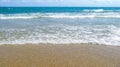 Sea salty pure blue waves roll on the sand of the local beach. Royalty Free Stock Photo