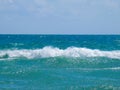 Sea salty pure blue waves roll on the sand of the local beach. Royalty Free Stock Photo