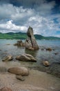 Sea sandy beach with large boulders of bizarre shapes Royalty Free Stock Photo