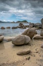Sandy sea beach with large stones in summer Royalty Free Stock Photo