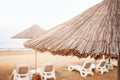 Sea sandy beach with many deck chairs.