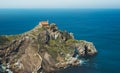 Sea scape on background gaztelugatxe steps sun huan, hipster girl looking on nature horizon ocean, relax holiday, blank space blue Royalty Free Stock Photo