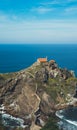 Sea scape on background gaztelugatxe steps sun huan, hipster girl looking on nature horizon ocean Royalty Free Stock Photo