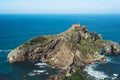 Sea scape on background gaztelugatxe steps sun huan, hipster girl looking on nature horizon ocean, relax holiday, blank space blue Royalty Free Stock Photo