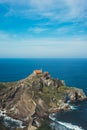 Sea scape on background gaztelugatxe steps sun huan, hipster girl looking on nature horizon ocean, relax holiday, blank space blue Royalty Free Stock Photo