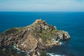 Sea scape on background gaztelugatxe steps sun huan, hipster girl looking on nature horizon ocean, relax holiday, blank space blue Royalty Free Stock Photo