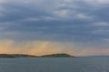 A marine landscape in the blue hour and a storm on the horizon.