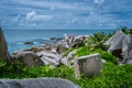 Sea scenery with white yacht on the trekking tour to secret Anse Marron beach, La Digue, Seychelles