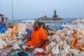 Sea shell seller with background view of Vivekananda Memorial Rock, in Kanyakumari, Tamilnadu