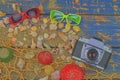 Sea shells on a blue background. Summer traveling time. Sea holiday background with various shells, sunglasses and vintage camera. Royalty Free Stock Photo