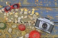 Sea shells on a blue background. Summer traveling time. Sea holiday background with various shells, sunglasses and vintage camera. Royalty Free Stock Photo