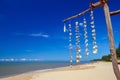 Sea shells hanging on strings at the beach of the Andaman Sea, Thailand