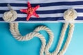 Sea shells, starfish and textile stiped navy bag with rope knots on light blue background. summer holiday and vacation concept Royalty Free Stock Photo