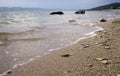 Sea shore, beach washed by the waves. Cloudy and stormy sky. Royalty Free Stock Photo