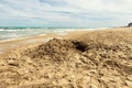 Sea shore with hole excavated into the sand