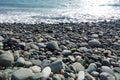 Sea shore with pebbles. wet sea pebbles on the beach and quiet sea surf Royalty Free Stock Photo