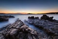 Sea shore with rocks at sunset. Seascape in summer time. Rocks and water. Long exposure. Mediterranean sea. Royalty Free Stock Photo