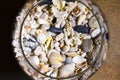 Sea shore shells, corals, stones in a glass bottle and wine glass