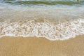 Sea shoreline with waves, sandy beach on a clear sunny day, close-up nature abstract background Royalty Free Stock Photo