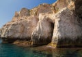 Sea side view of Siracusa coast cliffs, sandstone rocks and caves in sunny summer day. A bright colorful photo good for Royalty Free Stock Photo