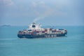 At sea, Singapore - cargo ship sailing through calm, blue sea.