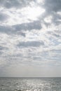 Sea and sky. Cloudy day. Marine background. Sun glare on the water. Royalty Free Stock Photo