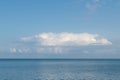 Blue sky and blue sea, white clouds. Beautiful seascape on a sunny day. Royalty Free Stock Photo