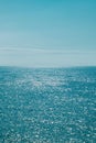 Blue sea and blue sky. Sun glare on the water. Marine background. Royalty Free Stock Photo