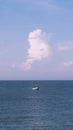 Sea sky cumulus cloud landscape view background. Calm water alone fishing boat. Destination aim progress concept Royalty Free Stock Photo