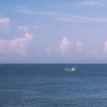 Sea sky cumulus cloud landscape view background. Calm water alone fishing boat. Destination aim progress concept Royalty Free Stock Photo