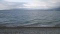 Sea and small sea stones. Clouds on sky