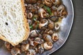 Sea snails cooking in a pan