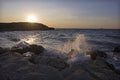Sea spray on the rocks of the shore in the evening light of the sunset. 1 Royalty Free Stock Photo