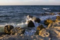 Sea spray on the rocks of the shore in the evening light of the sunset. 3 Royalty Free Stock Photo