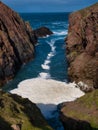 Sea spume or sea foam formed in West Ness Geo near North Ham on the island of Muckle Roe in Shetland, UK.