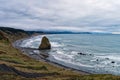 A sea stack dominates the beach on a foggy day at Cape Blanco State Park, Oregon, USA Royalty Free Stock Photo