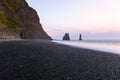 Deserted black pepple beach in Iceland in midnight sun light