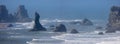 Sea stacks along the Pacific coast at Bandon, Oregon under hazy humid atmosphere Royalty Free Stock Photo