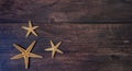 Sea stars. Summer nautical background - stars on wooden background