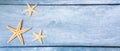 Sea stars. Summer nautical background - stars on wooden blue background